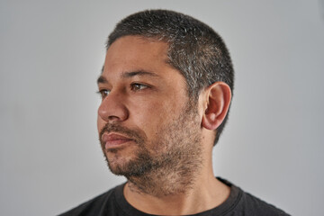 portrait of man looking to the left on neutral background