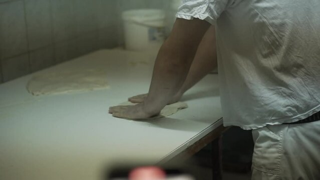 Traditional serbian balkanic food - burek. Man makes dough.