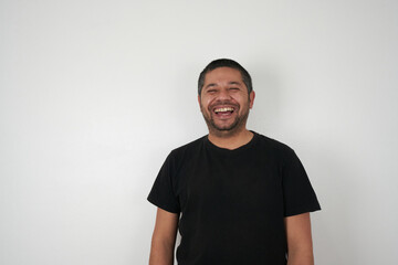 Smiling Man Poses Against Neutral Backdrop