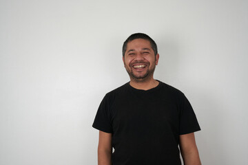 Man with a Neutral Background Smiles at Camera