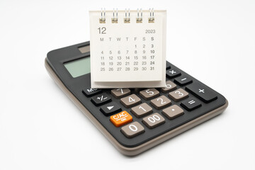 calculator and calendar DEC 2023 on white background for money and debt management concept....