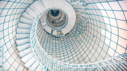 White spiral staircase with a blue tint embodies modern elegance and architectural brilliance. Its minimalistic design, abstract nature, and sleek curves make it a perfect example of contemporary art
