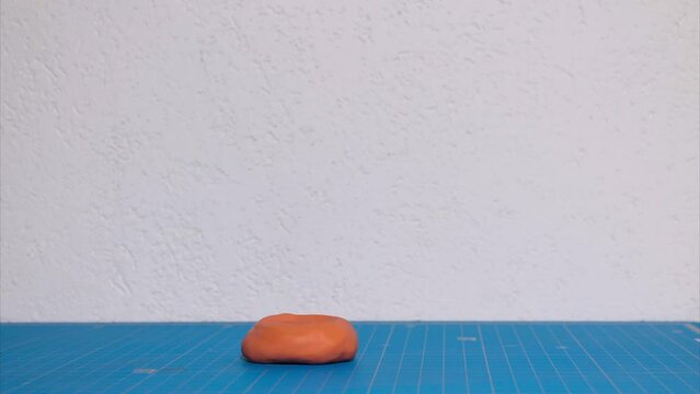 Plasticine stop motion animation. Morphing a human hand from a piece of body plasticine. A hand with five fingers appears in the frame