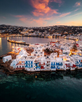 A stunning Mykonos vista: White houses against a breathtaking sea backdrop, a picture of Greek island paradise.