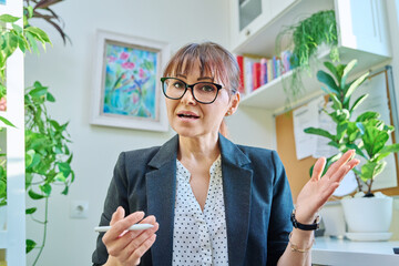 Web camera view of female teacher psychologist business manager talking in home office