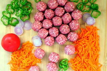 Raw meatballs made from ground pork and fresh vegetables