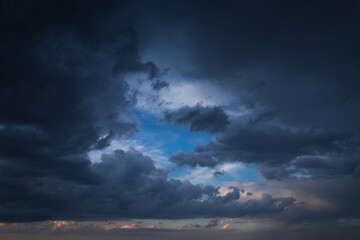 Epic Dramatic storm dark blue grey cumulus rain clouds on blue sky background, thunderstorm