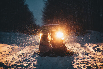 Young romantic couple is having fun outdoors in winter before Christmas. Enjoying spending time...