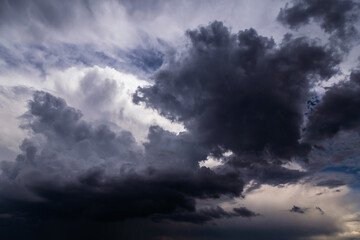 Epic Dramatic storm sky with dark grey black and white cumulus rain clouds background texture, thunderstorm