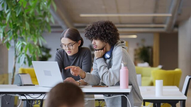 African American man and his colleague work harmoniously in an office, exemplifying the spirit of teamwork, diversity, and professional collaboration in a modern workplace