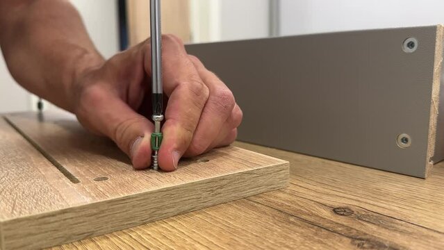 Assembling furniture with men's hands
