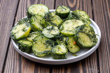 sliced dill pickles for hamburger top view. .Marinated  cucumbers with herbs and spices.