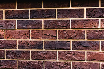 Weathered texture of stained old dark brown and red brick wall background, grungy rusty blocks of stone-work technology, colorful horizontal architecture