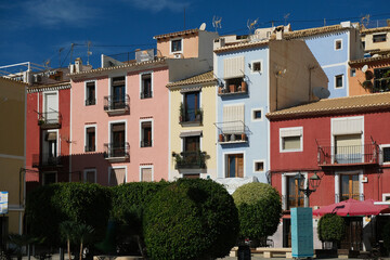 Fototapeta na wymiar La Vila Joiosa, Villajoyosa street with multi-colored houses. Villajoyosa is coastal town near Mediterranean Sea, Alicante province, Valencian community, Spain