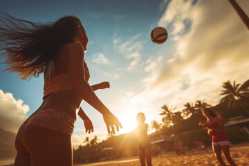 Beautiful girl close-up view in a sand beach volleyball game at sunset. Summer tropical vacation...