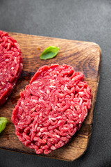 ground meat raw cutlet fresh beef meat hamburger eating cooking appetizer meal food snack on the...