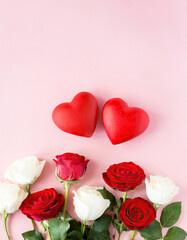 red hearts on a pink background with red and white roses