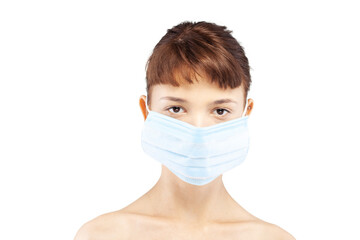 Portait of a beautiful girl wearing medical face mask against viruses pollution or dust. Looking at camera.