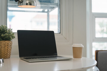 Workspace with black screen laptop on table. Working concept using technology