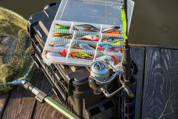 A large fisherman's tackle box fully stocked with lures and gear for fishing.fishing lures and...