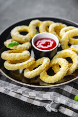 onion rings batter deep fryer tomato sauce fast food eating cooking appetizer meal food snack on the table copy space food background rustic top view