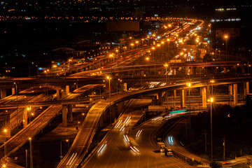 Highway and overpass in Bangkok city at night, road and aerial view