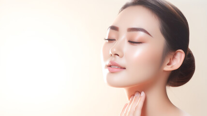 Beautiful asian girl model touching fresh glowing hydrated facial skin on beige background closeup. Beauty face. Skin care concept. Copy Space.

