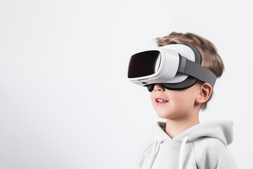 Young boy getting experience using VR headset glasses isolated on a white background with copy space