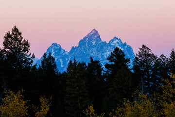 Landscape view during sunset of Middle Teton, Grand Teton and Mount Owen from the Bridger Teton National Forest in Wyoming