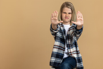 Teen girl putting hands up in a rejecting gesture