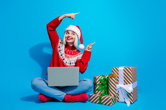 Full length photo of excited cute woman santa elf wear pullover sending x-mas congratulations empty space isolated blue color background