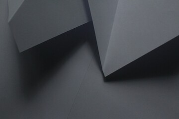 Black background with a creative arrangement of folded paper in various directions