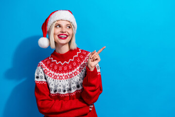 Obraz premium Portrait of gorgeous positive lady look indicate finger empty space festive proposition isolated on blue color background
