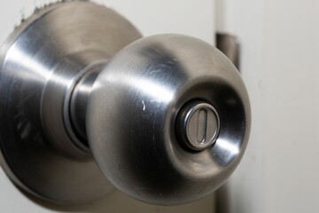 Closeup of a round door handle knob with push lock