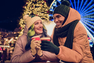 Photo of charming cute african guy lady dressed coats drinking x-mas beverages together outdoors...