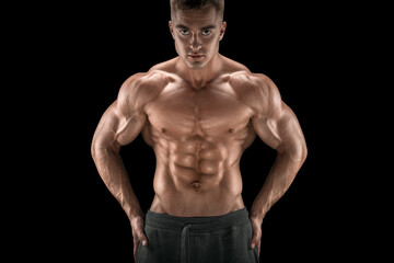 Young attractive male bodybuilder isolated on black