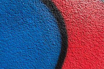 Abstract wall surface with part of graffiti. Geometric lines, light blue, black, red colors...