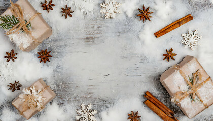 Obraz na płótnie Canvas christmas background with snowflakes, cinnamon and gifts. Copy space for text