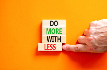 Do more with less symbol. Concept word Do more with less on beautiful wooden block. Beautiful...
