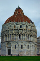 Picturesque landscape view of medieval Pisa Baptistery of St. John. It is Roman Catholic ecclesiastical building. Architectural icon of the city of Pisa, Italy. UNESCO World Heritage Site
