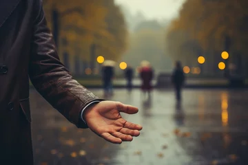 Deurstickers Rain is dropping on a man's hand.Sweet smell of rain © Olga