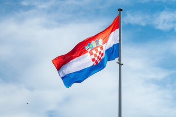 The national flag of Croatia waving in the blue sky