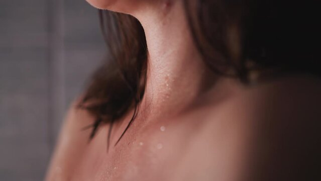 Young woman with problematic skin stands in shower. Naked lady waits for skin to dry to get out of bathroom. Bare woman with acne stands in bathroom