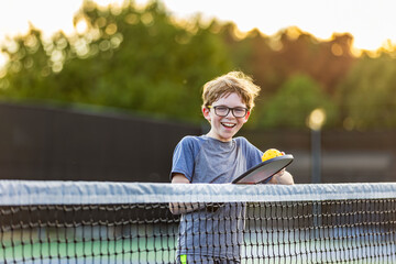Boy on court with pickleball gear