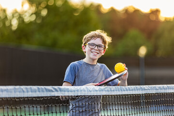 Boy on court with pickleball gear - Powered by Adobe