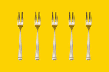 A collage of yellow colored forks