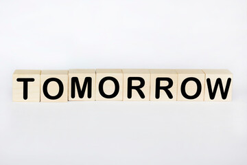 Tomorrow word written on wood blocks on desk