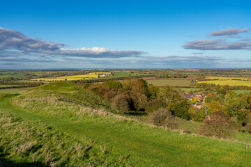 Vista from Burton Dassett Hills on a bright autumnal day with far reaching views over Warwickshire, England - 673894917