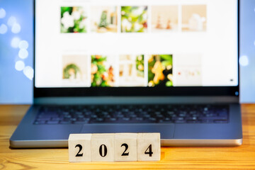 2024 wooden block on laptop background. Goal, task, resolution, strategy, plan, finance, budget, motivation and concepts for the beginning of the New Year.