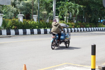 A simple means of transportation (becak) is parked in the Malioboro area of ​​Yogyakarta.